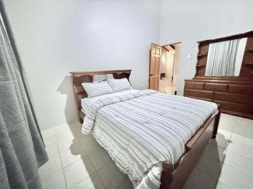 a bedroom with a bed with a striped comforter at TheWinterHouse in Crown Point