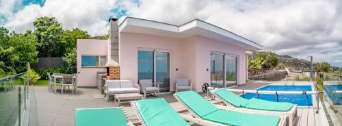 a villa with a swimming pool and blue chairs at Villa Azinhaga in Gaula