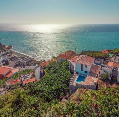 an aerial view of a village next to the ocean at Camara De Lobos Lux Villa in Câmara de Lobos