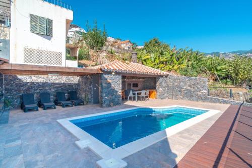 a villa with a swimming pool and a house at Camara De Lobos Lux Villa in Câmara de Lobos