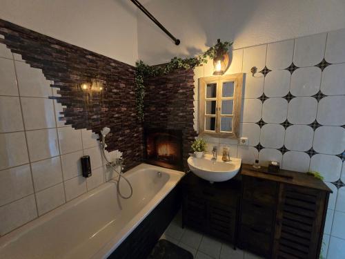 a bathroom with a sink and a bath tub and a sink at Magische Welt in Bautzen