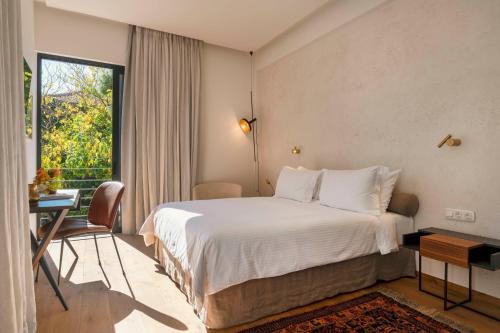 a hotel room with a bed and a window at Nõs Luxury Rooms in Missolonghi