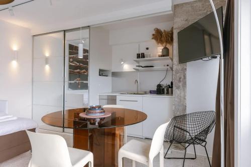 a kitchen with a table and chairs in a room at Sea views - beachfront - in the heart of Knokke-Heist in Knokke-Heist