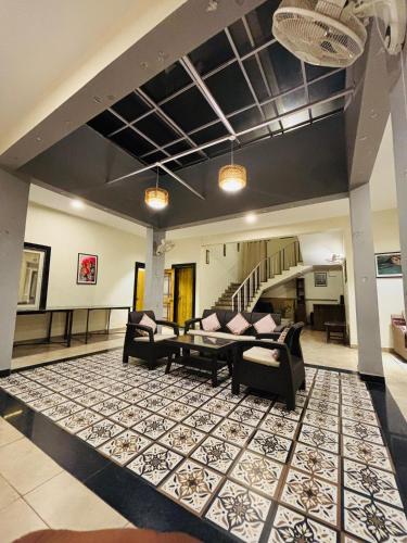 a living room with two couches and a rug at Courtyard Villa in Bhopal