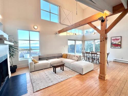 a living room with a couch and a table at The Beach Barn & Cedar Sauna in Kingsburg