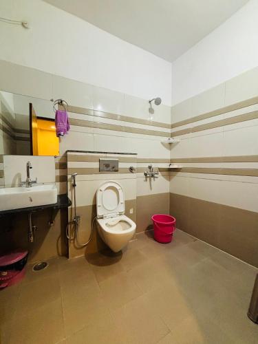 a bathroom with a toilet and a sink at Courtyard Villa in Bhopal