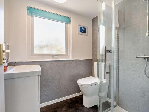 a bathroom with a toilet and a sink and a window at 2 Bed in Ringwood oc-94272 in Saint Leonards