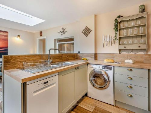 a kitchen with a sink and a washing machine at 3 Bed in Freshwater oc-92961 in Freshwater