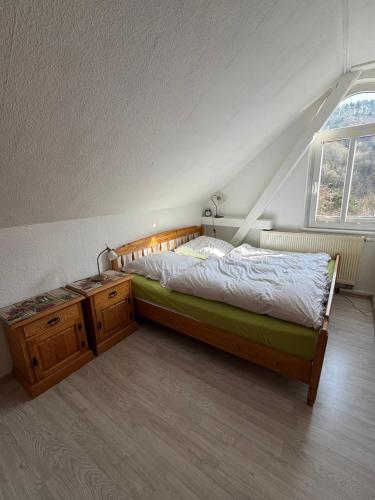a bedroom with a large bed and a window at Im Herzen des Elbsandsteingebirges in Königstein an der Elbe