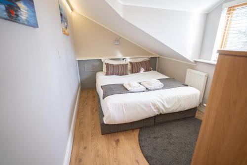 a small bedroom with a bed in a attic at Alensgrove Maisonette B in Leixlip