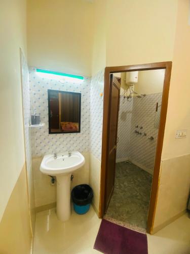 a bathroom with a sink and a shower at Negi Lodge Chandigarh in Chandīgarh