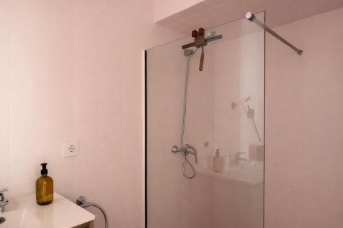 a shower with a glass door in a bathroom at Winahost La Llar del Mar in San Pol de Mar