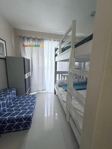 a bedroom with two bunk beds and a window at Sparkle2600 at Megatower 1 in Baguio