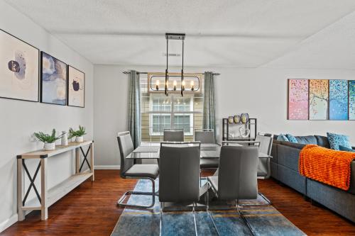 a dining room with a table and a couch at Spacious Corporate Condo - 2bd/2ba in Madison