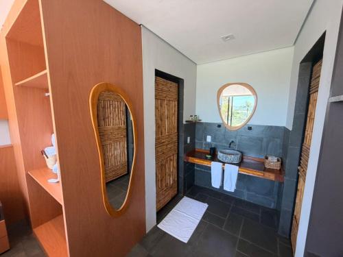 a bathroom with a sink and a mirror at Hotel Boutique Vila don Patto in São Roque
