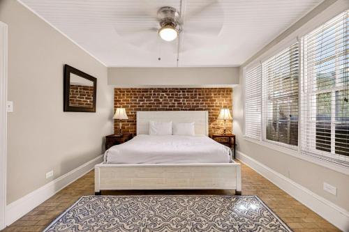 a bedroom with a bed and a brick wall at Troup Square Manor Garden by Lucky Savannah in Savannah