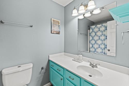 a bathroom with a sink and a toilet and a mirror at Spacious Corporate Condo - 2bd/2ba in Madison