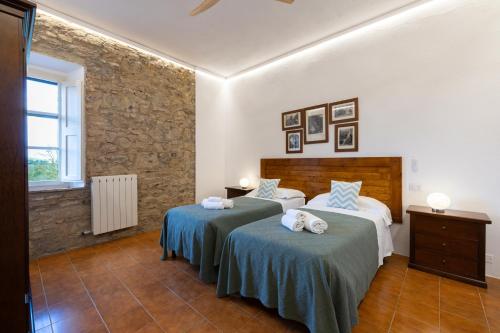 a bedroom with two beds with towels on them at Tipico casolare toscano Tenuta della Selva in Murlo