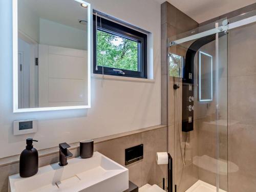 a bathroom with a sink and a glass shower at 2 Bed in Skipton oc-86230 in Elslack