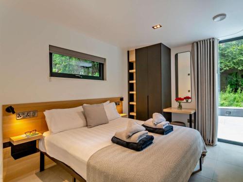 a bedroom with a large bed with towels on it at 2 Bed in Skipton oc-86230 in Elslack