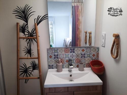 a bathroom with a sink and a mirror at Les chambres de Noëlla in LʼAiguillon-sur-Vie