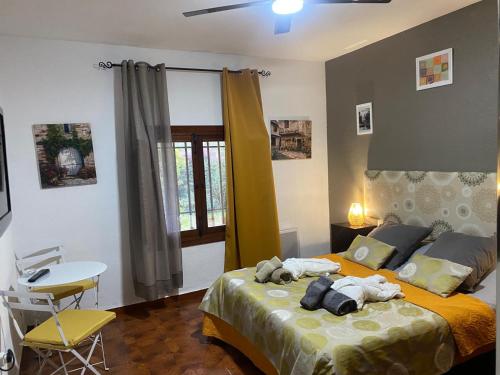 a bedroom with a bed with stuffed animals on it at Casa Rural Paloma B&B in Benajarafe