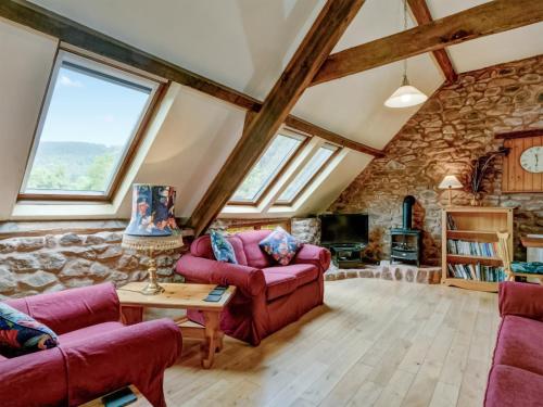 a living room with a stone wall at Luccombe- Ukc4919 in Timberscombe