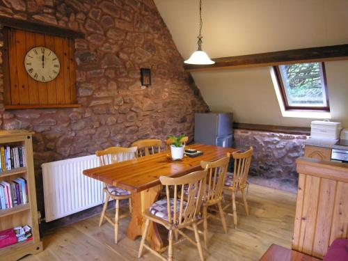 a dining room with a wooden table and chairs at Luccombe- Ukc4919 in Timberscombe