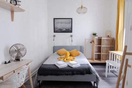 a bedroom with a bed with a teddy bear on it at AppartUnique - Chez Layette - Hypercentre & Design Moderne in Vichy