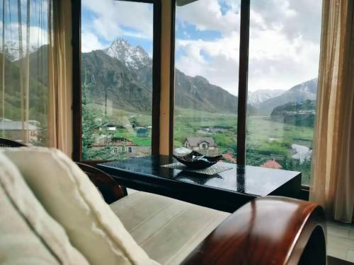 a room with a table and a large window at Vardisubani Villa in Kazbegi