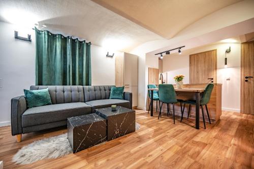 a living room with a couch and a table at Urban Base CELJE in Celje