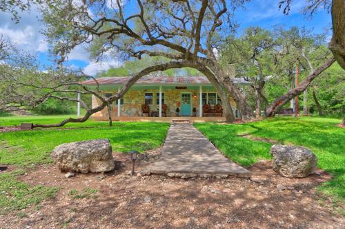 a house with two large rocks in front of it at Arbor Creek in Wimberley