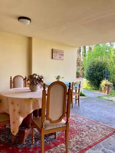 a dining room with a table and chairs and a table and chairs at B&B Mama Rò in Cesena