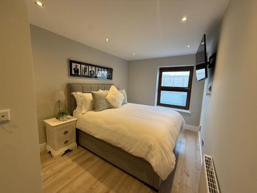 a bedroom with a bed and a window at Coastal Charm in Dublin
