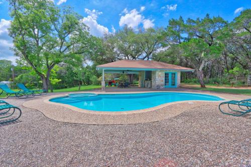 an image of a swimming pool in front of a house at Arbor Creek in Wimberley