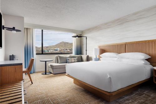 a bedroom with a large white bed and a couch at Salt Lake City Marriott University Park in Salt Lake City