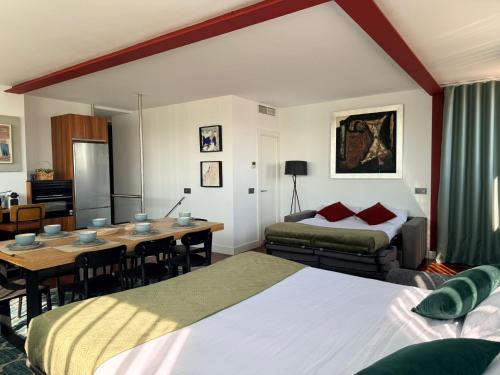 a hotel room with a dining table and a bedroom at Apartamentos Libertad 24 in Madrid
