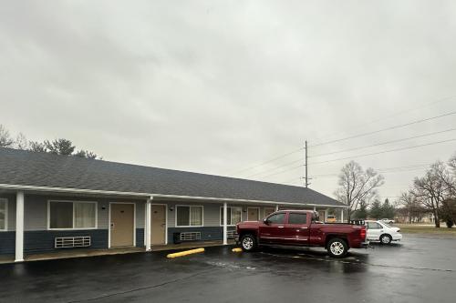 a red truck parked in front of a building at Budget Inn by Hotel O Greensville I 70 in Greenville