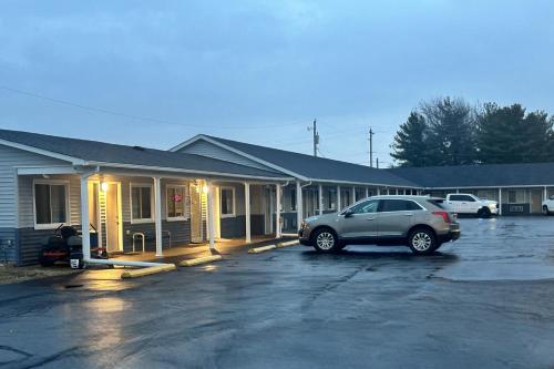 a car parked in a parking lot in front of a building at Budget Inn by Hotel O Greensville I 70 in Greenville
