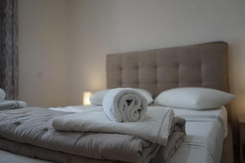 a bedroom with a bed with towels on it at Pythari Summer House in Laganas