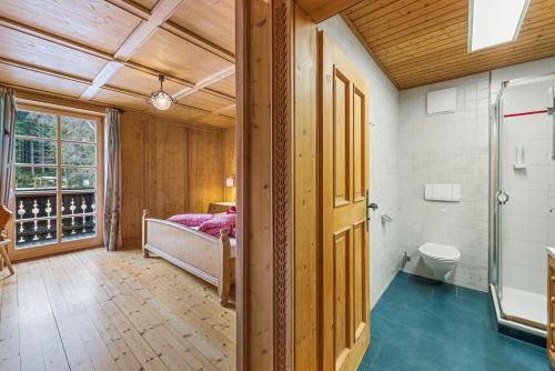 a bedroom with a bed and a toilet in a room at Blaa Alm in Altaussee