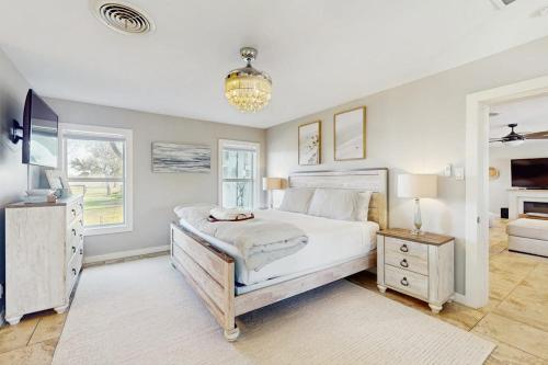 a bedroom with a large white bed and windows at R&R Acres in Aransas Pass