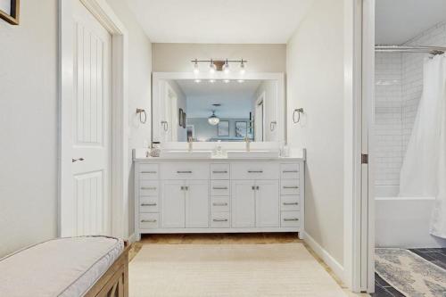 a white bathroom with a sink and a mirror at R&R Acres in Aransas Pass
