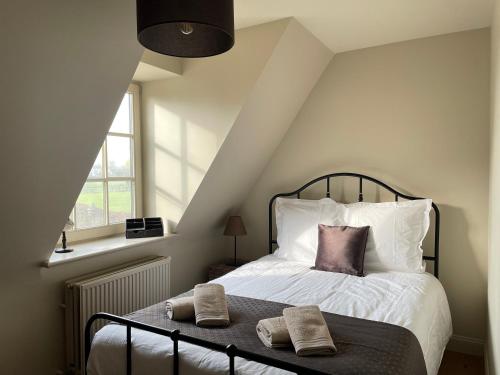 a bedroom with a bed with two pillows on it at Vakantiehuis Vloethem in Zedelgem