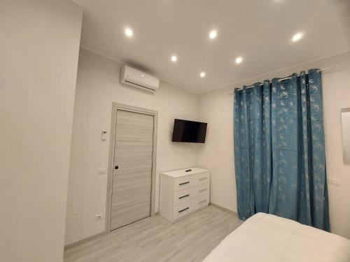 a bedroom with a bed and a dresser and a tv at Grazia Nest in Ciampino
