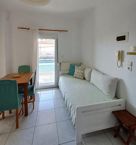 a living room with a couch and a dining room table at Vassilikos Apartment in Flogita