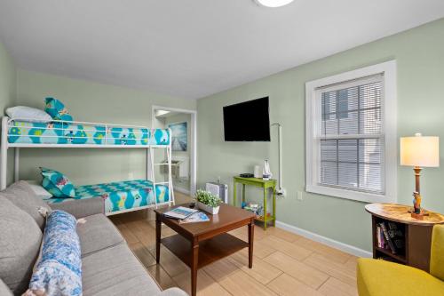 a living room with a couch and a bunk bed at Vitamin Sea Suites 4 in Carolina Beach