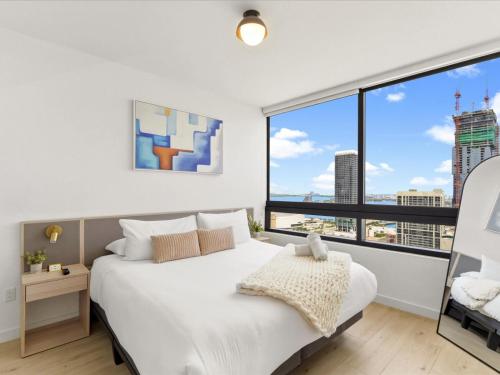 a bedroom with a large white bed and large windows at Prime Downtown Miami Location with Rooftop Pool in Miami