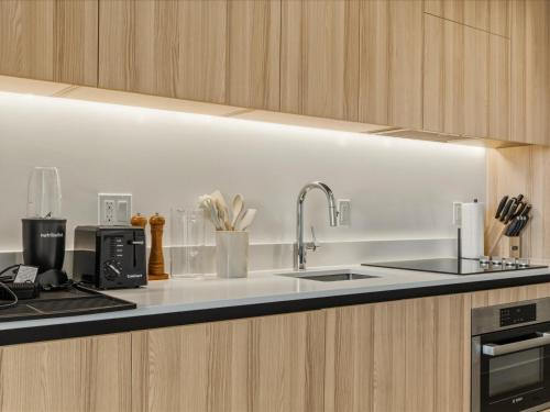 a kitchen with a sink and a counter top at Prime Downtown Miami Location with Rooftop Pool in Miami