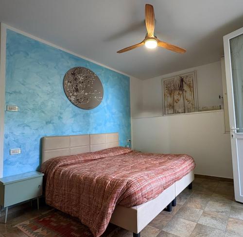 a bedroom with a bed and a ceiling fan at B&B Mama Rò in Cesena